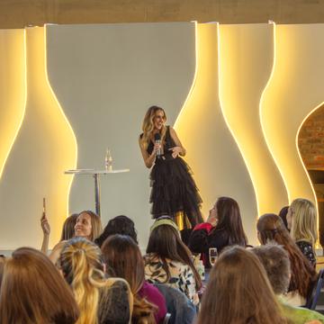 Christie on stage at a Boss Moms event