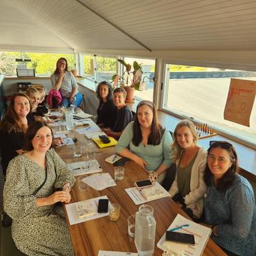 A pod around a long table at a meetup